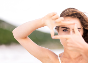 Lady creating a box with fingers denoting her vision