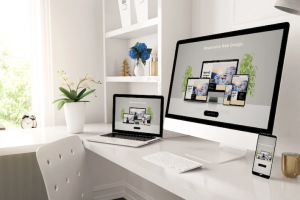 Laptop, PC and mobile on top of an office desk of an SEO specialist